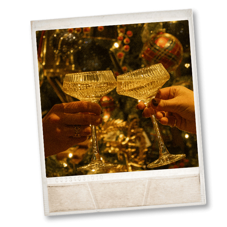 Poloroid of two champagne glasses clinking together in celebration